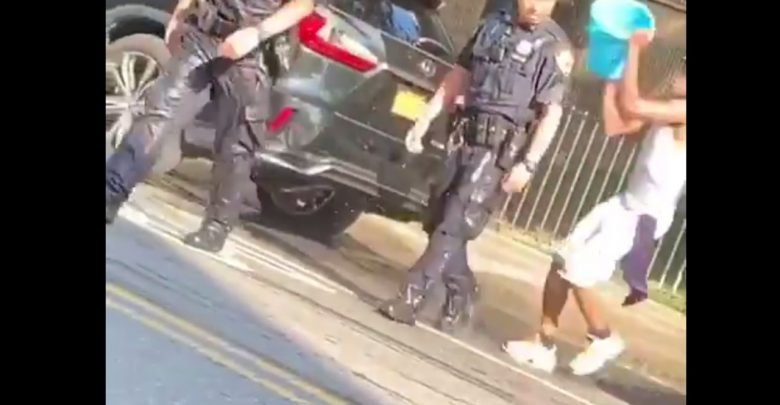 NYPD officers on-duty get humilited by having water thrown at them by a group of men