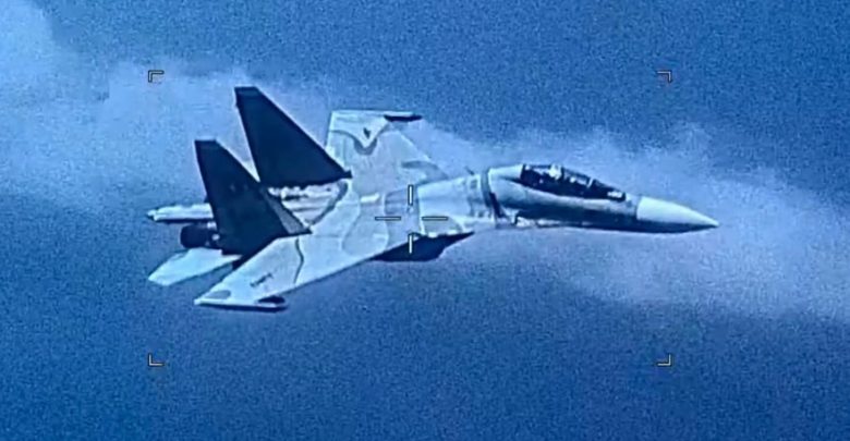 a Venezuelan sU-30 fighter jet intercepts a US Navy EP-3 II surveillance aircraft during a scheduled mission on Friday