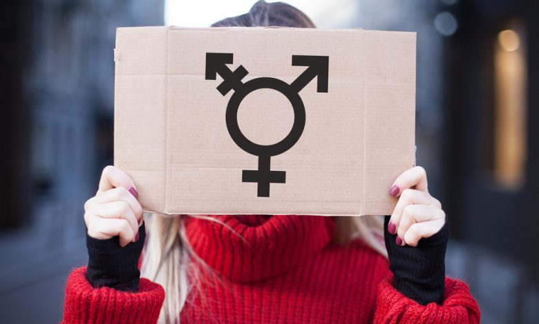girl holding transgender symbol sign