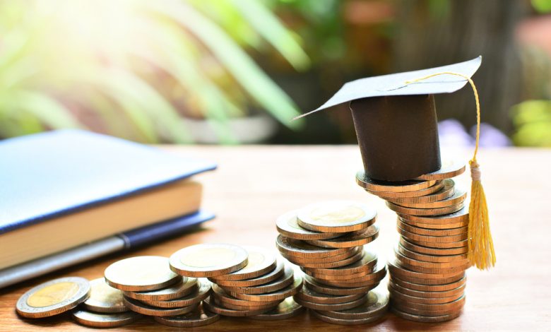 Photo of Graduation Cap On Top of Stack of Change.