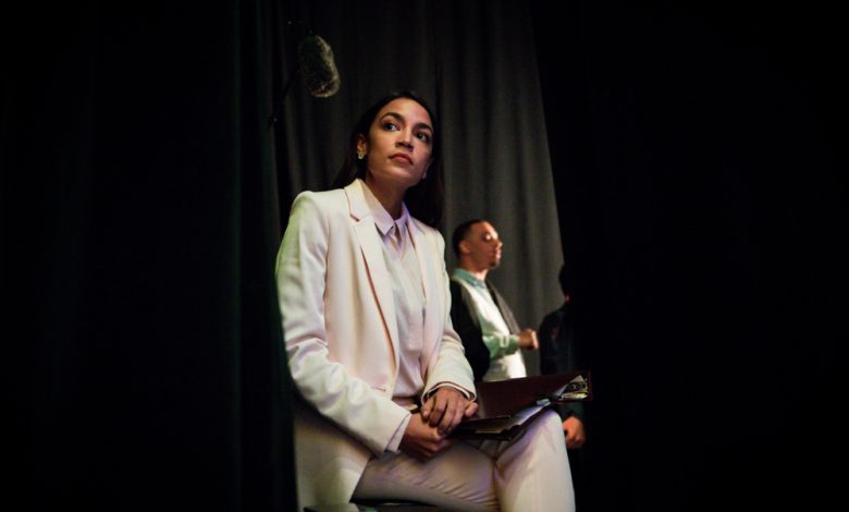 AOC Sits waiting to speak.