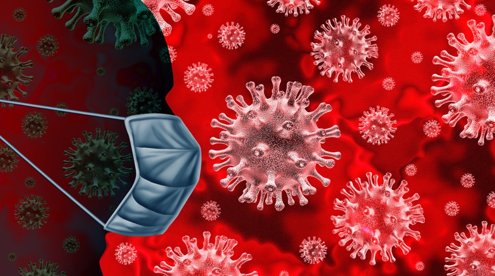 Image of man wearing a face mask, coronavirus molecules in the background.