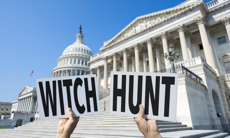 Image of Capital Hill with man holding Witch Hunt signs.