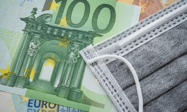 Image of one hundred Euro bill and a surgical mask.