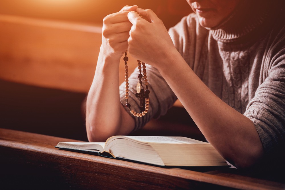 Christian woman praying in church.