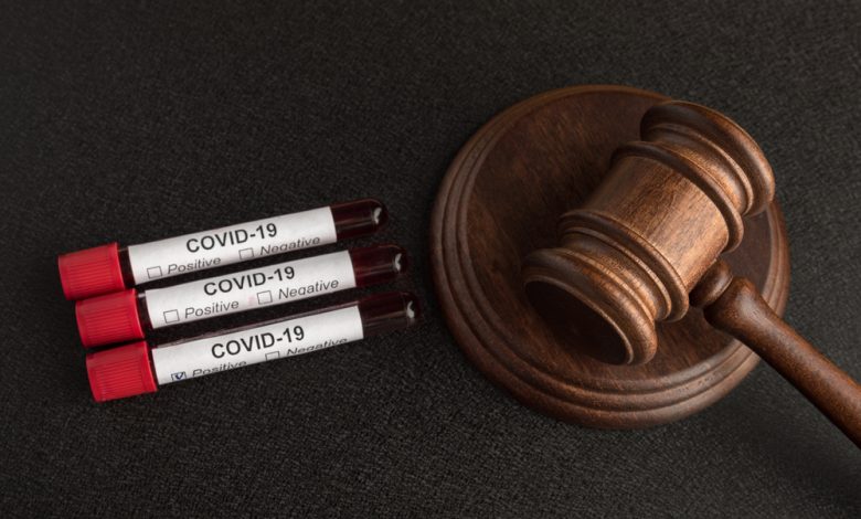 COVID-19 blood samples next to a judge's gavel.
