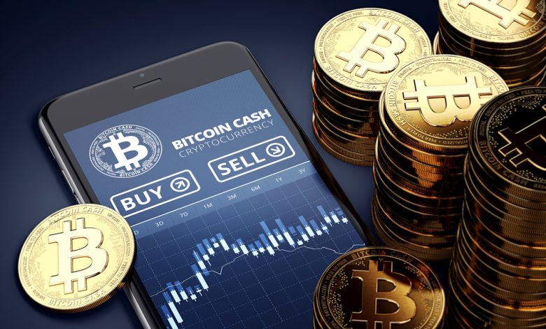 Image of Smartphone with Bitcoin tokens lying around.