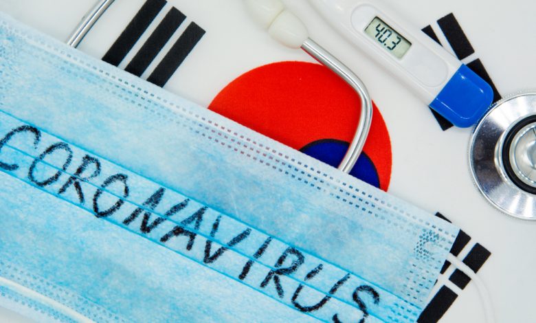 Protective breathing mask, stethoscope on top of a South Korean flag.