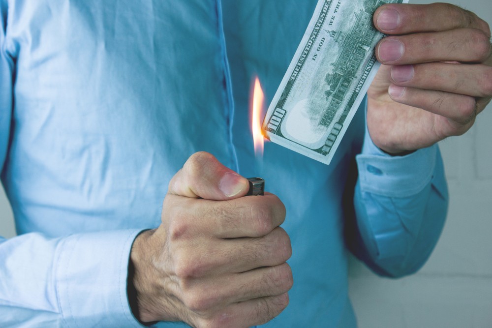 Man burning money.