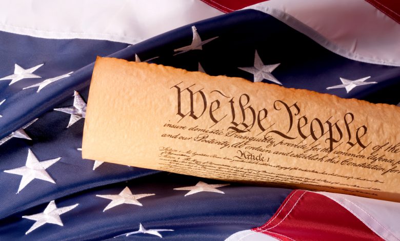 Image of the American Constitution on top of a flag.