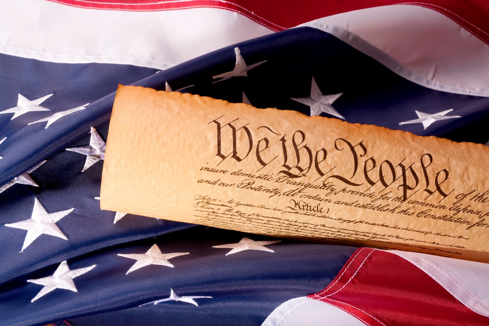 Image of the American Constitution on top of a flag.