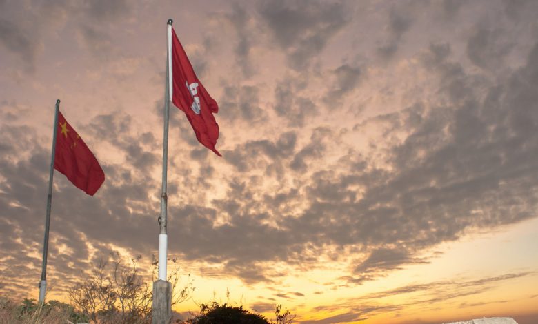 Image of China and Hong Kong flags side by side..