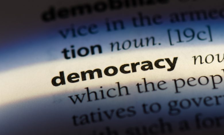 Image of the word democracy on a dictionary.