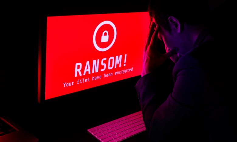 Computer screen with ransomware attack file encrypted alert.