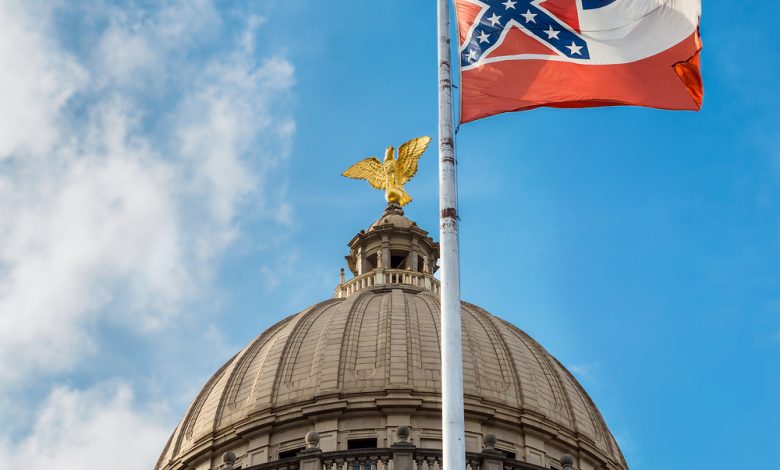 Mississippi state flag flying in front of the capitol building in Jackson.
