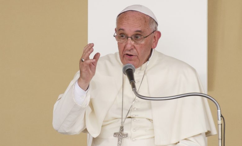 Image of Pope Francis speaking on microphone.