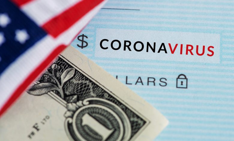 Concept of coronavirus relief showing an American flag over a dollar and check with the words “coronavirus”