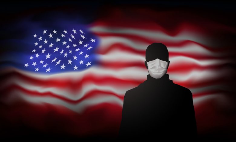 Silhouette of man in medical mask on abstract of an American flag background.