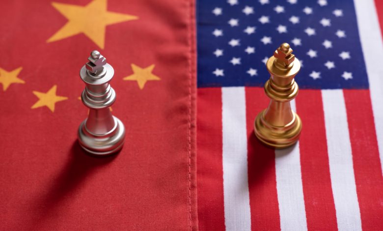 Chess game, two king stand confront on China and US national flags.