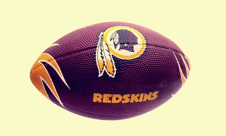 American football with Washington Redskins logo.