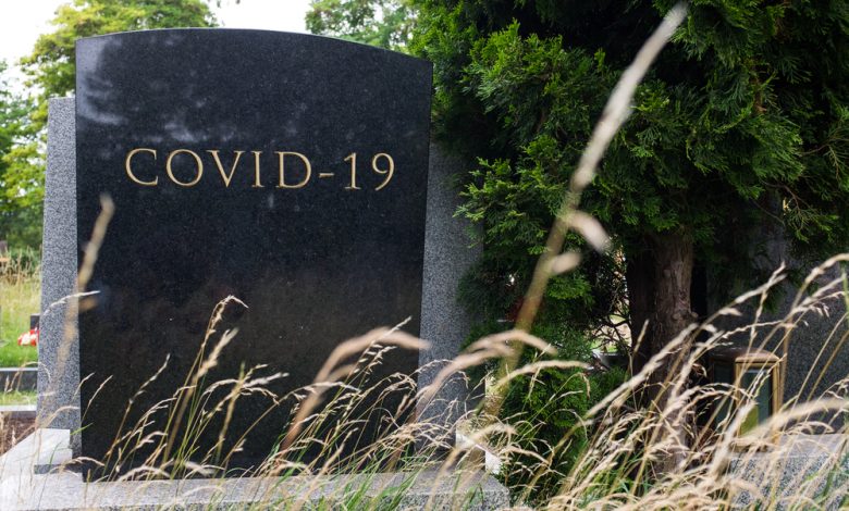 Gravestone with the word COVID-19 carved in stone.