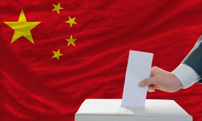 Man putting his ballot in a box during elections in china.