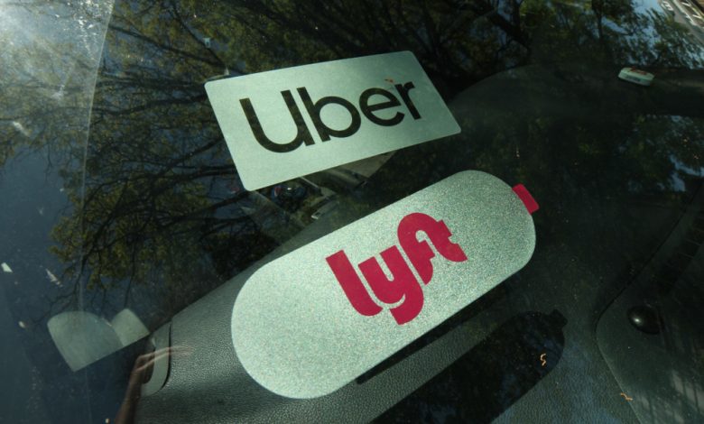 Lyft and Uber sticker on a driver’s windshield.