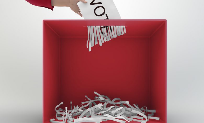 A paper shredder used as a ballot box.