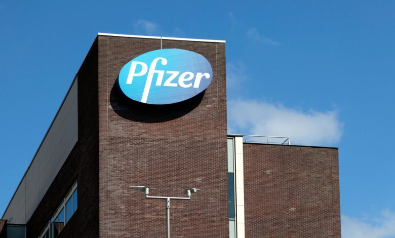 Close up shot of the "Pfizer" office building with the logo on the side.