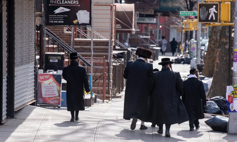 Jewish father and sons are seen walking to Sabbath Prayers as the coronavirus continues to spread across the United States.