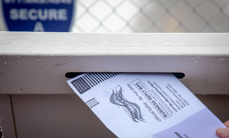 Image of mail in ballot dropped off at ballot box