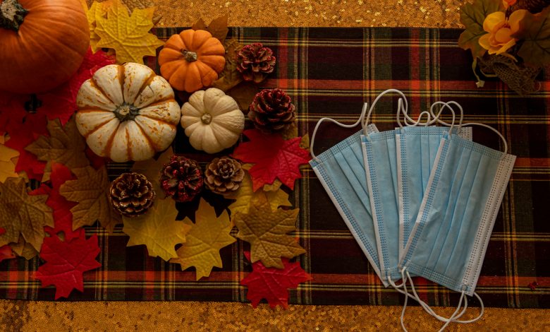 Thanksgiving celebration with facemasks and pumpkins.