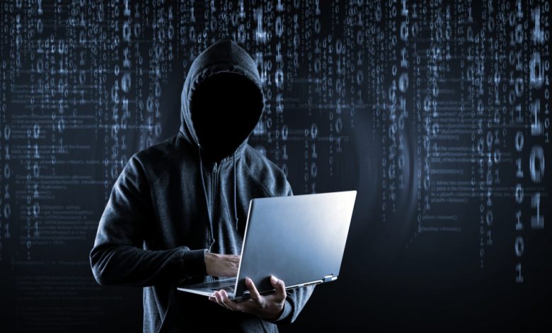 Hacking and malware concept depicting a Hacker using a laptop.