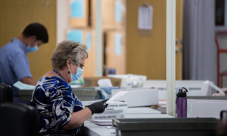 Election poll workers wearing masks during the 2020 elections.
