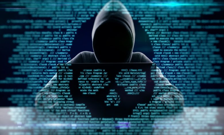 Cyberattack concept image depicting a hacker with code overlay in the shape of a skull