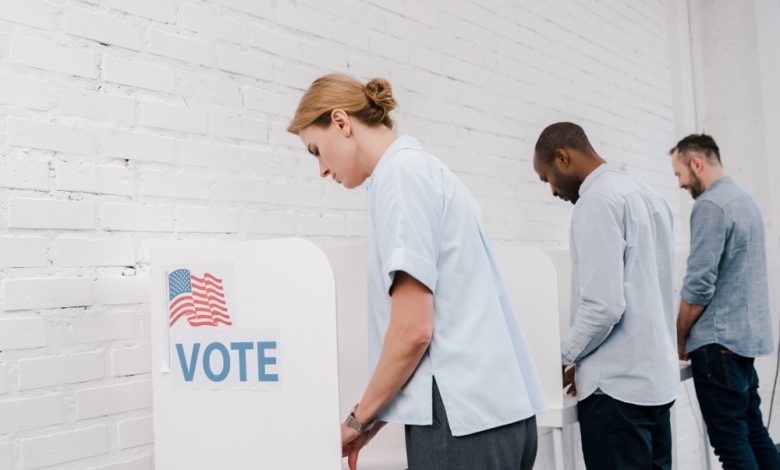 Americans voting in voting booths.