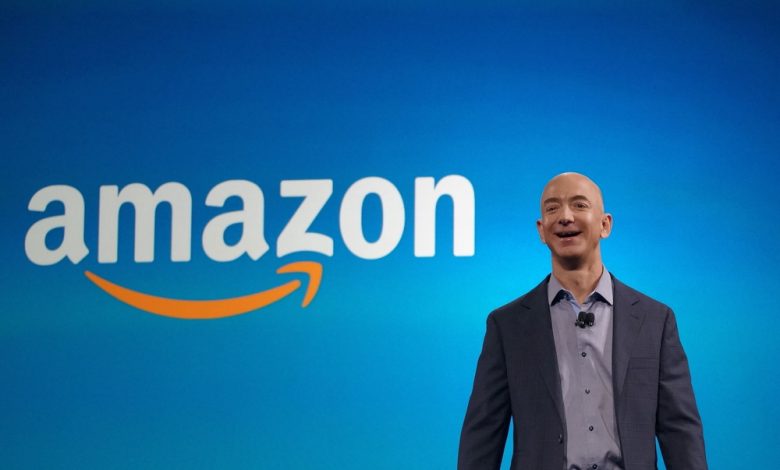 Amazon CEO Jeff Bezos in front of the company's logo.