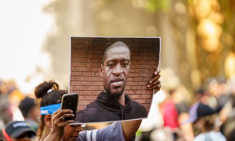 Protesters holding an image of George Floyd during the demonstrations following his killing.