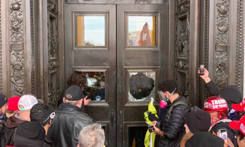 Image showing rioters breaking into the Capitol building.