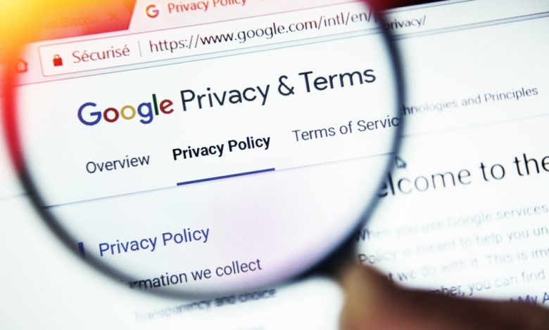 Magnifying glass on a computer screen outlining Google’s privacy policy.