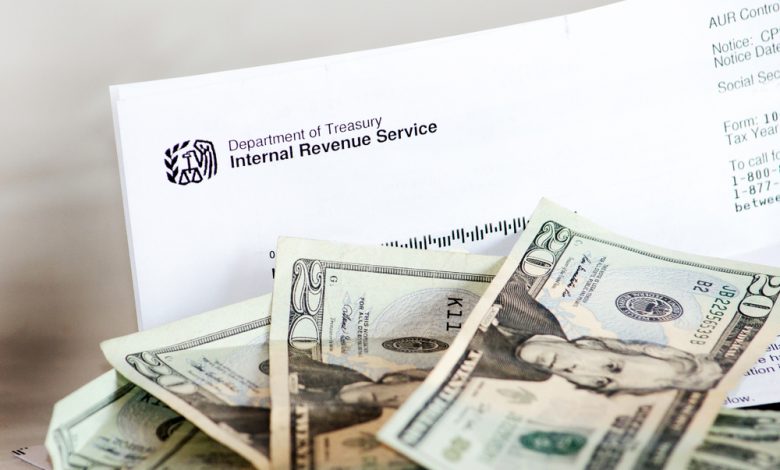 Image of IRS form with $20 dollar bills.