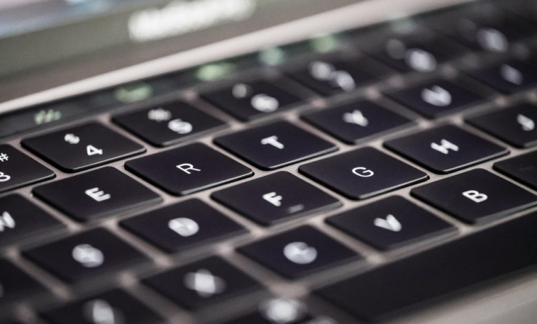 Close-up, shallow focus of a MacBook back-lit keyboard.