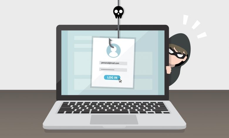Hacking concept data phishing with cybercriminals hides behind laptop computers.