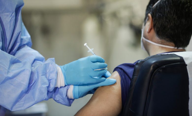 Man receiving Pfizer Covid-19 vaccine.