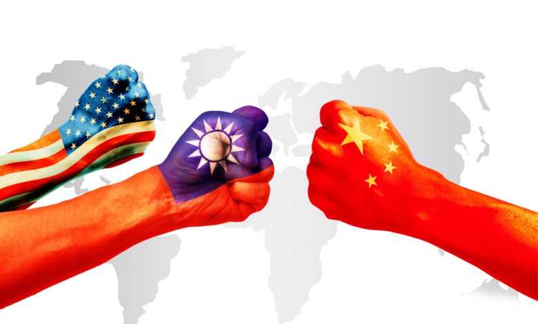Flags of US or United States of America, Taiwan and China on a clenched fist with the world map on the background.