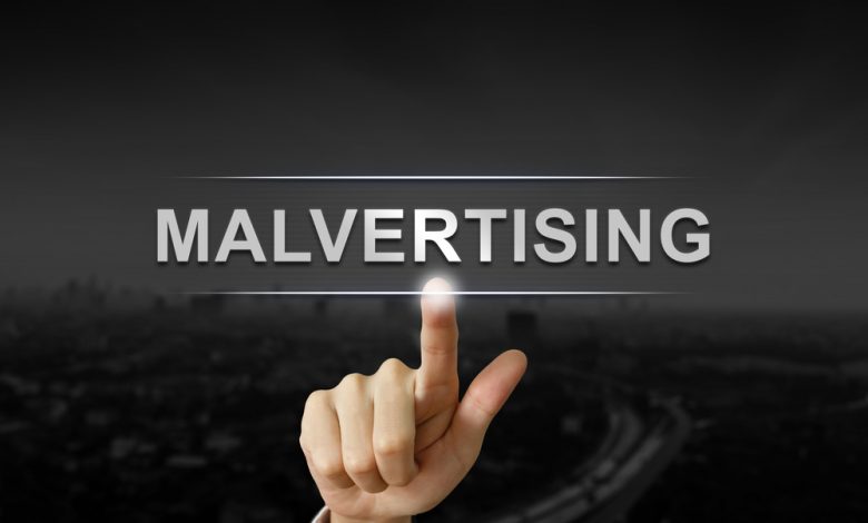 business hand clicking malvertising button on black blurred background