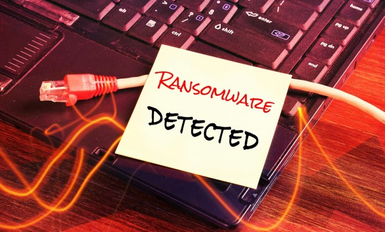 Network cable unplugged from the computer as a RANSOMWARE virus is attacking all computer system. paper written note "RANSOMWARE DETECTED" as a warning