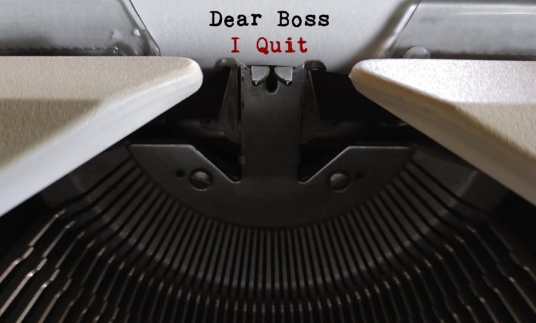 typewritter and paper with the words "Dear boss, I quit.""