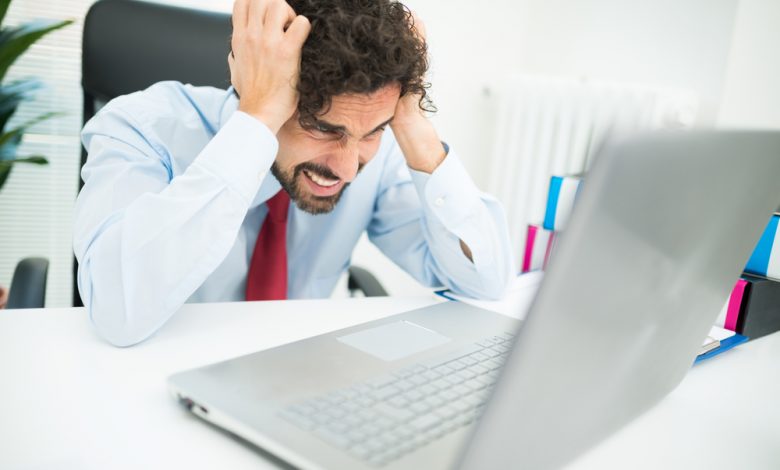 Angry businessman looking at his computer.