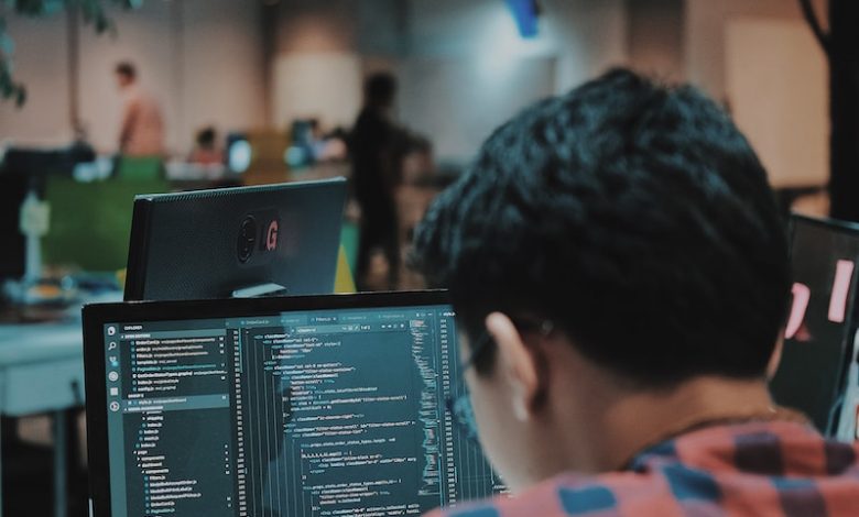 sitting man using gadget in room